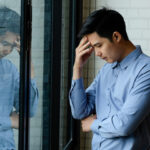 sad man in window
