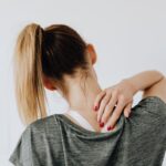 woman grabbing neck in pain